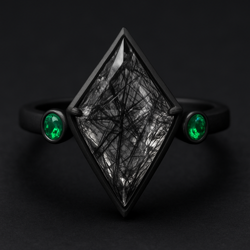 Kite cut Black rutilated quartz with emerald accent stones on a black band