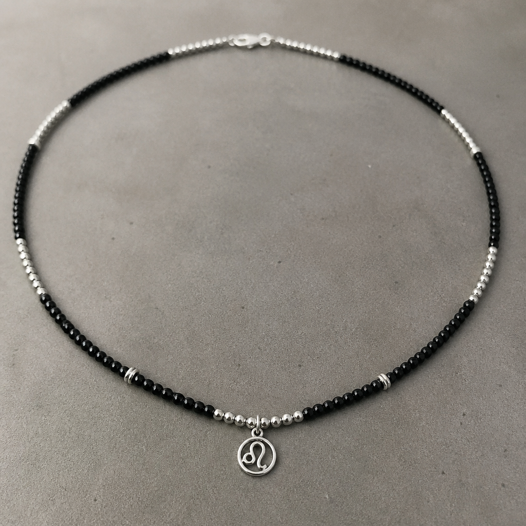 A beaded men's necklace made of silver, ultra-minimalist, very simple and clean, understated, no embellishments. Create a men's necklace approximately 50-60 cm long with occasional metal accents (spacers) and black onyx. The necklace should feature a charm with the Leo zodiac sign as an initial, without a background and not too large. just a simple charm without background or any details in a simple circle.
photorealistic jewelry design, A beaded men's necklace made of silver, ultra-minimalist, very simple and clean, understated, no embellishments. Create a men's necklace approximately 50-60 cm long with occasional metal accents (spacers) and black onyx. The necklace should feature a charm with the Leo zodiac sign as an initial, without a background and not too large. just a simple charm without background or any details in a simple circle., beaded style, just the design no text