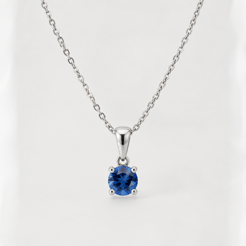 A realistic sterling silver necklace with a delicate chain, a small blue sapphire pendant, polished silver, elegant and minimal, professional jewelry product photography.
photorealistic jewelry design, A realistic sterling silver necklace with a delicate chain, a small blue sapphire pendant, polished silver, elegant and minimal, professional jewelry product photography., just the design no text
