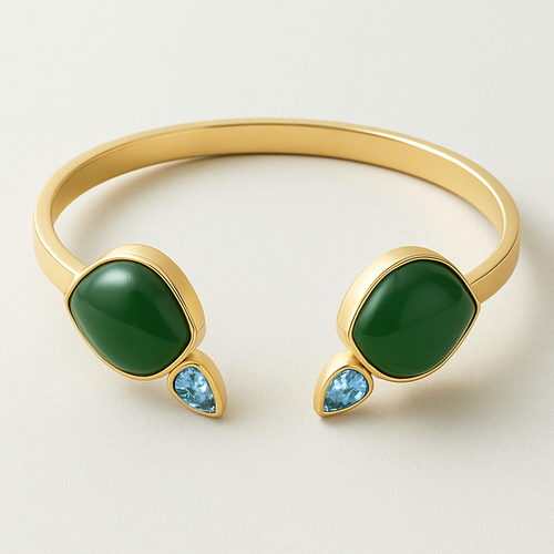 Create a yellow gold cuff with two pear shaped pieces of nephrite jade at the ends and two petite pear shaped blue topaz’s set in the gold of the bracelet