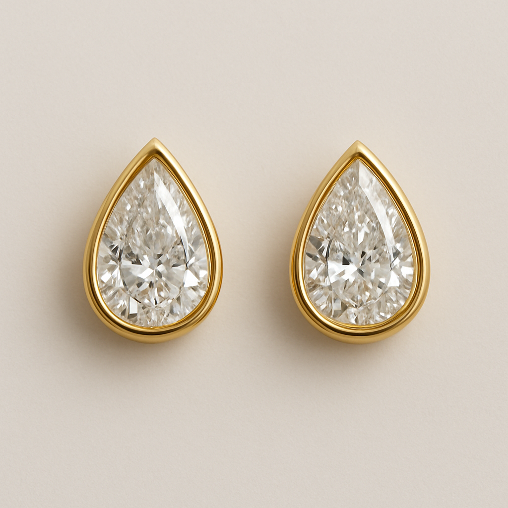 A pear shaped diamond eraings with a gold borders 