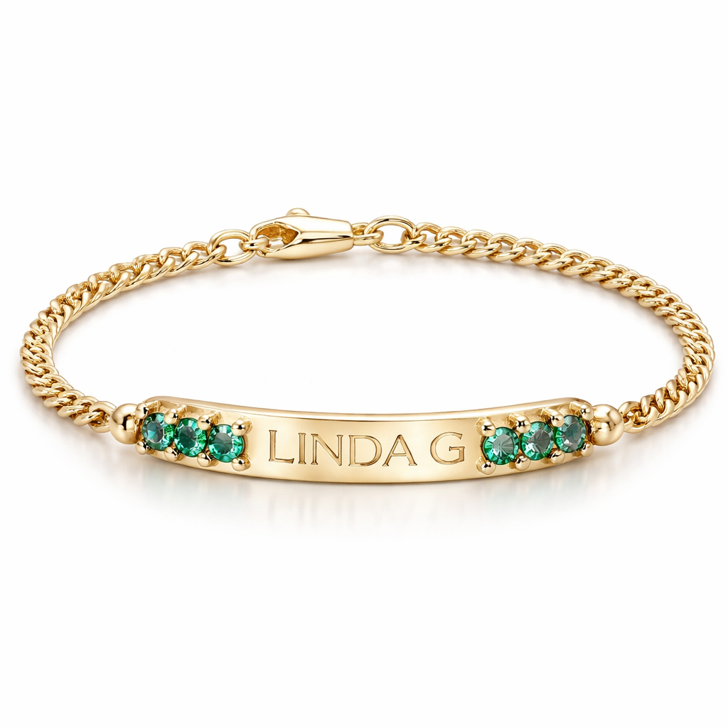 A women's ring. pulsera de bebe con esmeraldas en la placa y oro y placa q diga LINDA G y sea muy delgada con tejido cubano q sea la mejor