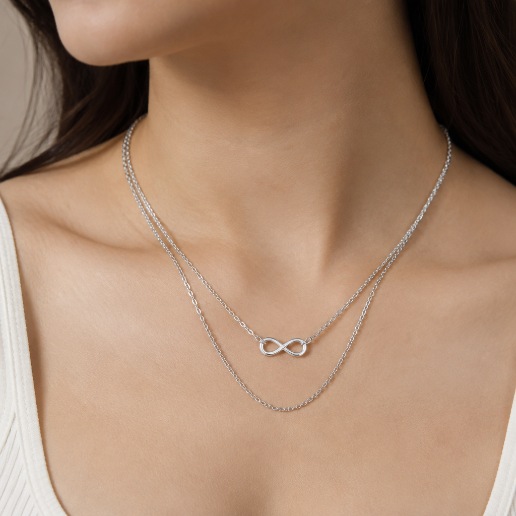 A infinity women's necklace made of silver suitable for daily wear. a simple silver chain 2 layers but the bottom one attached from the middle of upper chain
photorealistic jewelry design, A infinity women's necklace made of silver suitable for daily wear. a simple silver chain 2 layers but the bottom one attached from the middle of upper chain, infinity style, just the design no text