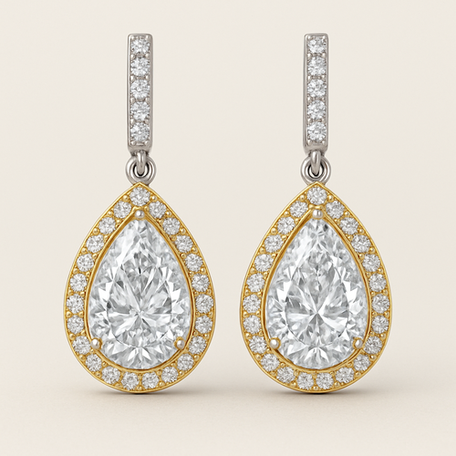 A pear shaped lab grown diamond eraings in white gold a gold borders 