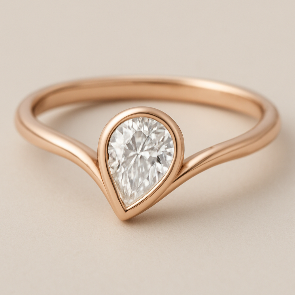 A refined 0.50 diamond  pinky ring and elegant rose gold ring featuring a pear-shaped diamond set in a smooth bezel setting. The diamond is tilted slightly to the side, creating a paisley-inspired shape reminiscent of a graceful flowing droplet. The rose gold band is sleek and polished, complementing the organic, curving silhouette of the stone. The design blends modern minimalism with a subtle artistic twist inspired by the Bandana paisley motif.