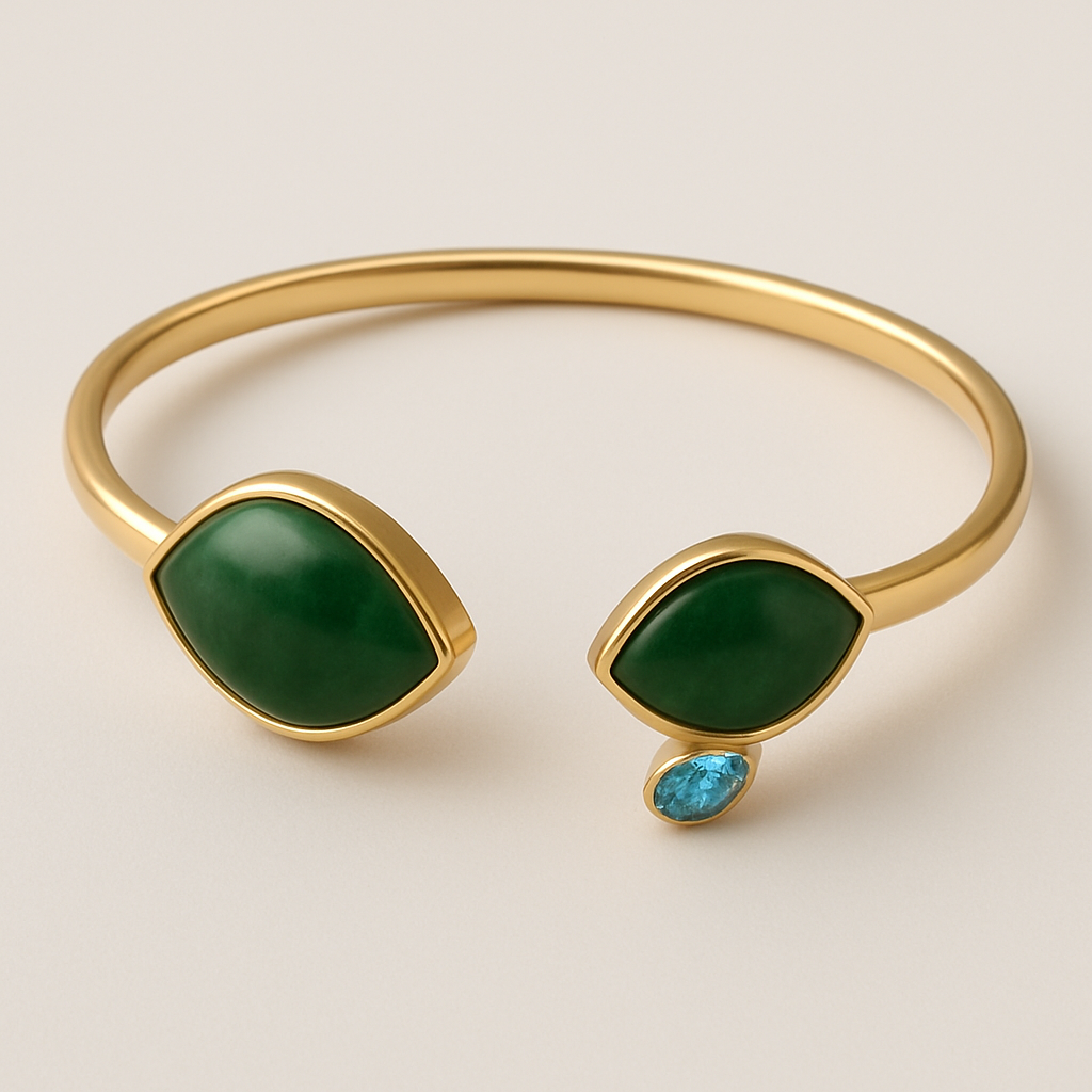 Create a yellow gold cuff with two pear shaped pieces of nephrite jade at the ends and two petite pear shaped blue topaz’s set in the gold of the bracelet