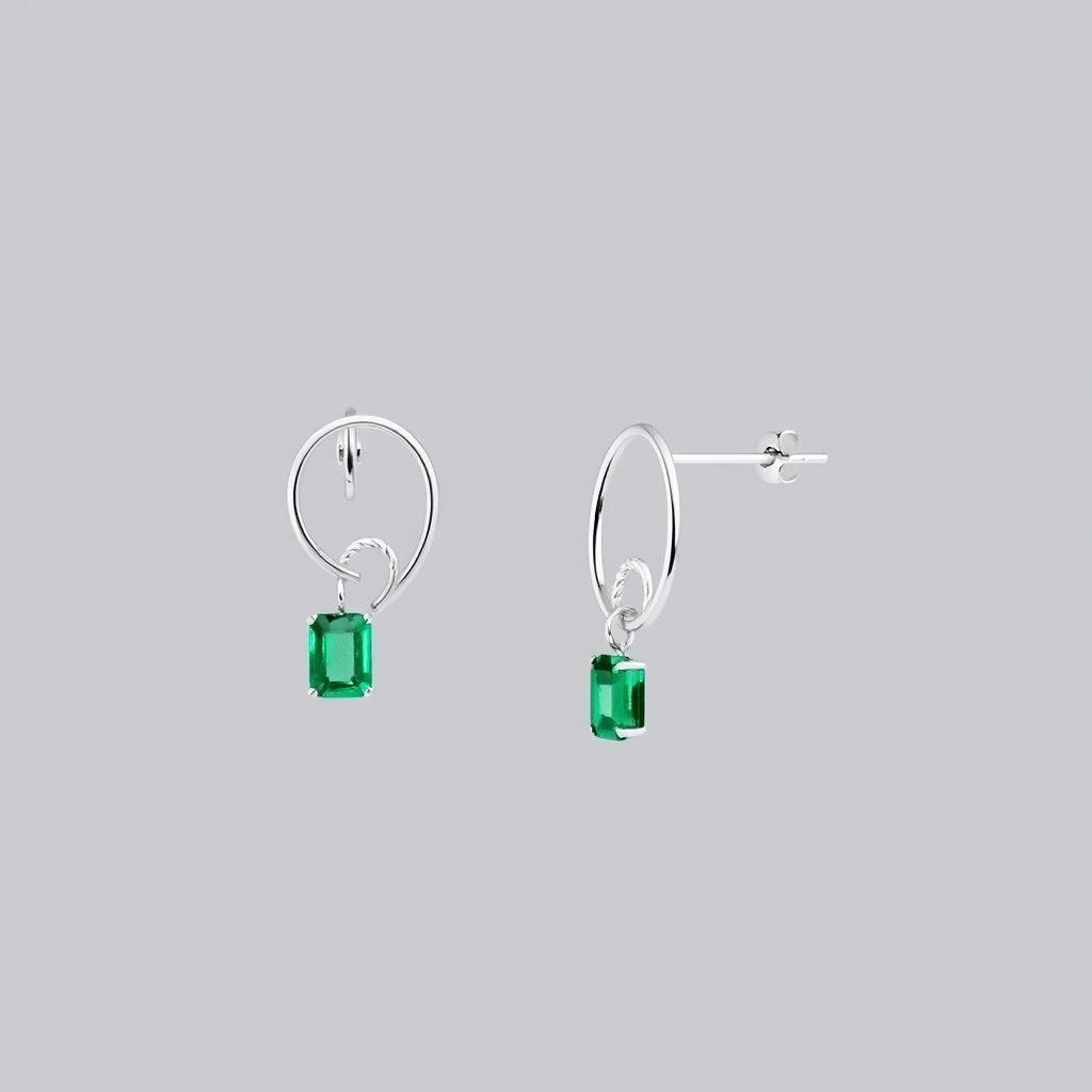 Small loop white gold earrings with emerald cut emerald hanging
Design a pair of sleek, minimalist white gold earrings featuring a delicate small loop. At the center, an emerald-cut emerald dangles gracefully, showcasing its deep green hues. Emphasize contemporary elegance with asymmetrical lines and a polished finish, creating a striking balance between geometric form and organic beauty for the modern wearer.