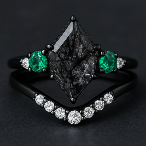 Kite cut Black rutilated quartz with 1 emerald on each side and 3 moissanite on each side accent stones in a cluster on a black band, separate wedding band black with moissanite stones that curves around the main stone 