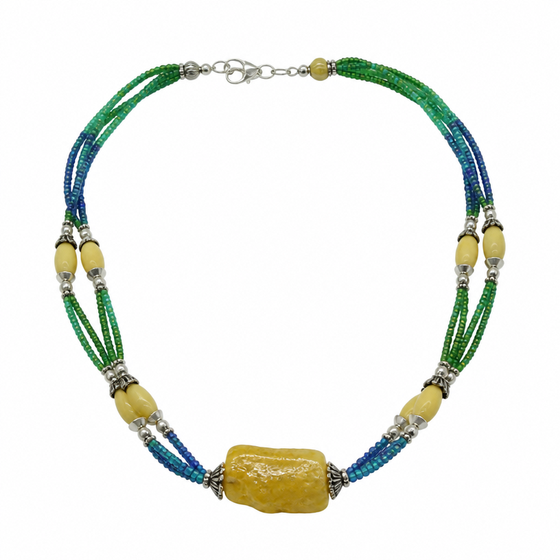A tribal women's necklace suitable for daily wear. black lines represent triple strand of seed beads (green to blue) with silver representing larger yellow to white beads. Focal bead is the rough cut yellow carp.
using the attached image as a visual reference, create A tribal women's necklace suitable for daily wear. black lines represent triple strand of seed beads (green to blue) with silver representing larger yellow to white beads. Focal bead is the rough cut yellow carp.. photorealistic, just the design no text