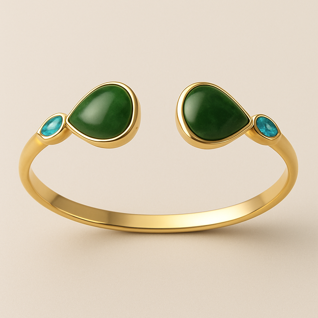 Create a yellow gold cuff with two pear shaped pieces of nephrite jade at the ends and two petite pear shaped blue topaz’s set in the gold of the bracelet