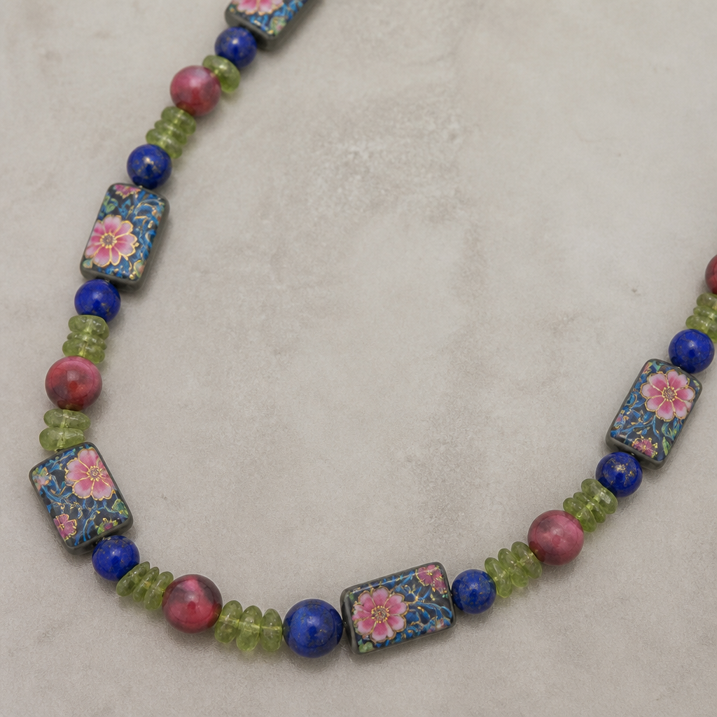 "12mm rectangular hand painted beads with pink flowers and blue vines with green and yellow spots, 8mm lapis round beads, pink tigers eye round beads
8.5 mm, 4-5mm peridot chips necklace "
photorealistic jewelry design, "12mm rectangular hand painted beads with pink flowers and blue vines with green and yellow spots, 8mm lapis round beads, pink tigers eye round beads
8.5 mm, 4-5mm peridot chips necklace ", nature_inspired style, just the design no text