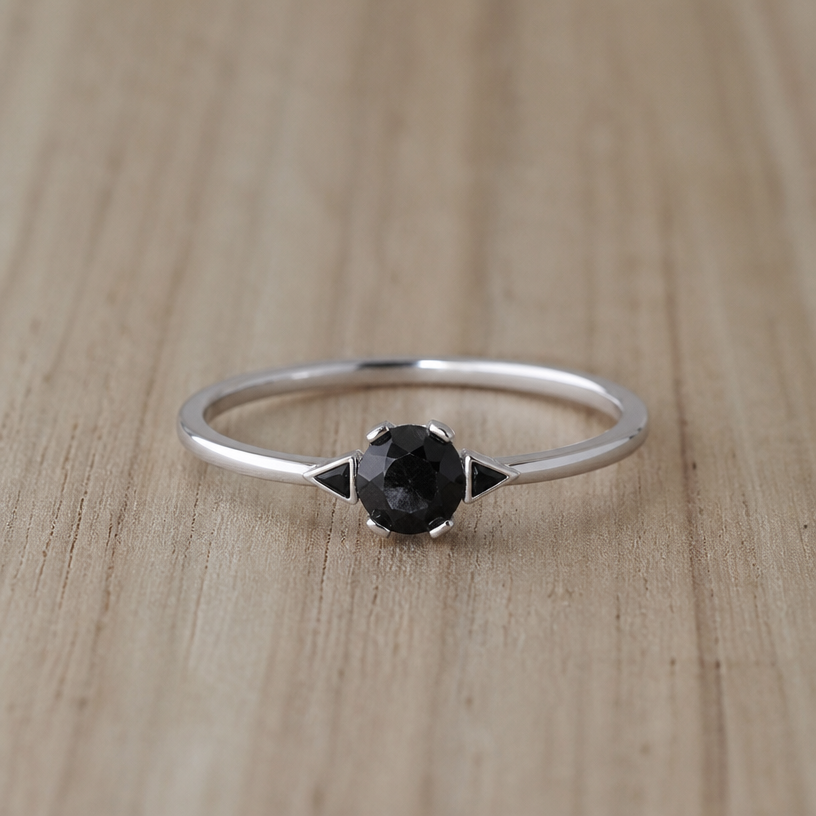 A women's ring made of silver, ultra-minimalist, very simple and clean, understated, no embellishments. take this black onyx and make some triangles outside the stone on either side
using the attached image as a visual reference, create A women's ring made of silver, ultra-minimalist, very simple and clean, understated, no embellishments. take this black onyx and make some triangles outside the stone on either side. photorealistic, just the design no text
