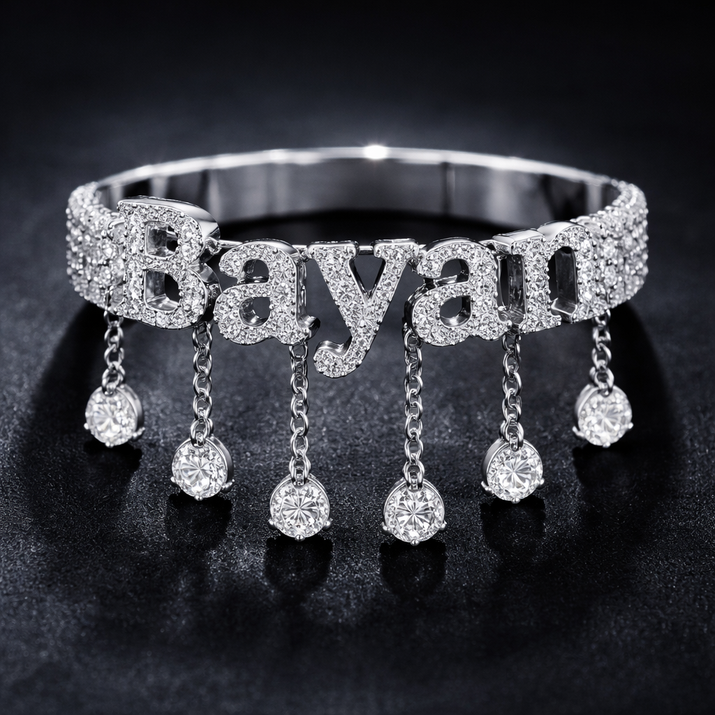 A luxury women's ring. A silver-colored bracelet with writing on it. "Bayan"Between each letter is a short, dangling chain, the end of which contains a soft diamond.
A luxury women's ring. A silver-colored bracelet with writing on it. "Bayan"Between each letter is a short, dangling chain, the end of which contains a soft diamond., luxury style