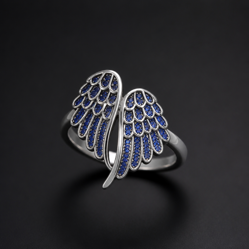 A women's ring with sapphire stones. angel wings on a stainless steel chain
using the attached image as a visual reference, create A women's ring with sapphire stones. angel wings on a stainless steel chain. photorealistic, just the design no text