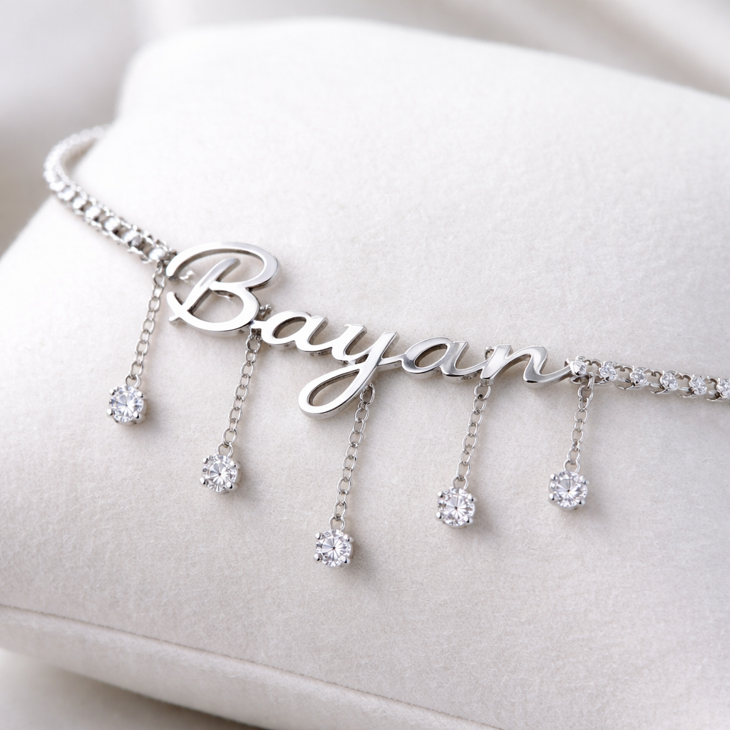 A women's bracelet. A silver-colored bracelet with writing on it. "Bayan" Between each letter there is a short, dangling chain with a diamond at its end, like B Then a dangling chain ،a Then, for a hanging chain like this, I want the design to be very smooth and the letters very smooth.
A women's bracelet. A silver-colored bracelet with writing on it. "Bayan" Between each letter there is a short, dangling chain with a diamond at its end, like B Then a dangling chain ،a Then, for a hanging chain like this, I want the design to be very smooth and the letters very smooth., modern style