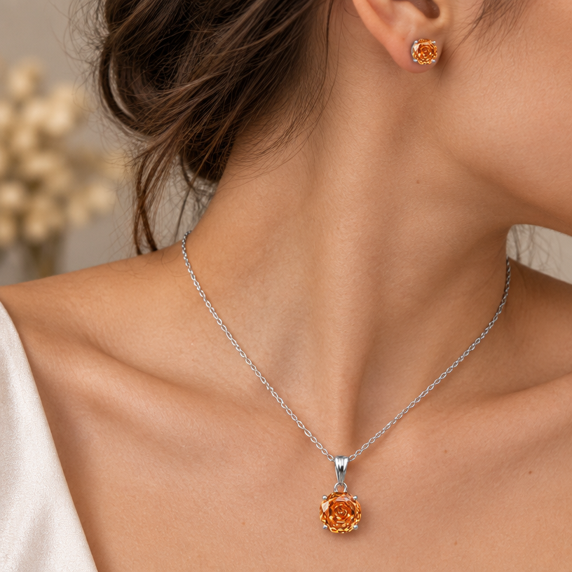 Jewelry photoshoot (worn)
Show the jewelry piece from the image worn by an elegant model in a professional editorial photograph, soft studio lighting. Reproduce the jewelry's exact design, metal, stones and details faithfully. Photorealistic, no text. Additional instructions: "Close-up editorial jewelry photo of a woman's neck, collarbone, ear, and upper chest, cropped so the face is fully out of frame. She wears soft, elegant clothing, only a small part of the fabric visible at the edge of the frame.
VARY THE POSE: do not repeat the same head tilt, shoulder position, or framing as previous generations. Use natural variations such as: head turned left or right, chin slightly up or down, one shoulder raised or relaxed, hair swept to either side or tucked back, camera angle shifted slightly higher or lower. Keep the framing tight on the neck, collarbone, and ear (face always out of frame), but make the pose feel distinct and natural.
She wears a sterling silver necklace with a round, multi-faceted orange/amber cubic zirconia pendant (cut with a spiral, rose-flower faceted pattern) set in a four-prong setting, and a matching pair of round faceted orange cubic zirconia stud earrings with the same spiral rose-cut faceting.
METAL FINISH: the sterling silver must be rhodium-plated — bright, cool-white, and reflective with a polished mirror-like shine, not dull or matte. The metal should catch light naturally, without looking overly glossy, plastic, or artificially glowing.
STONE COLOR AND DETAIL: the cubic zirconia stones must be a vivid orange-amber color, sparkling and perfectly faceted with a distinctive spiral rose-cut pattern, catching light realistically with natural brilliance and multiple light reflections.
STRICT SIZE REQUIREMENT: the pendant (including bail) must be exactly 2cm height, and the earrings exactly 0.6cm each, true to real-life scale against the neck, collarbone, and ear. Do not enlarge or oversize — the pendant should look elegant on the chest, not bulky or overly large.
SKIN REALISM REQUIREMENT: skin must look completely natural and photorealistic — visible fine skin texture, natural pores, subtle imperfections, soft even tone. Avoid any smooth, plastic, airbrushed, CGI, or overly retouched look. Lighting soft and warm, casting natural gentle shadows.
CHAIN AND PENDANT POSITION: fine cable chain draping naturally in a soft V-shape along the collarbone, with the round pendant hanging centered at the lowest point of the chain, attached by a teardrop-shaped bail. The stud earrings sit naturally and securely on the earlobes, fully visible and in focus.
Background softly blurred, warm and neutral, shallow depth of field. Mood: elegant, minimal, intimate — natural high-end jewelry brand photography style, face not shown, jewelry clearly and accurately rendered in true color and correct scale..