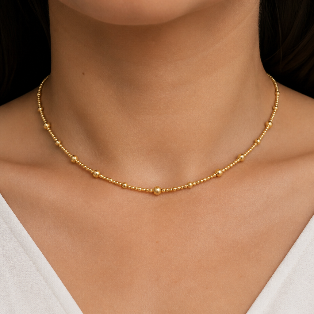 A women's necklace made of gold. 1mm golden beads and 0mm golden beads single thushi design