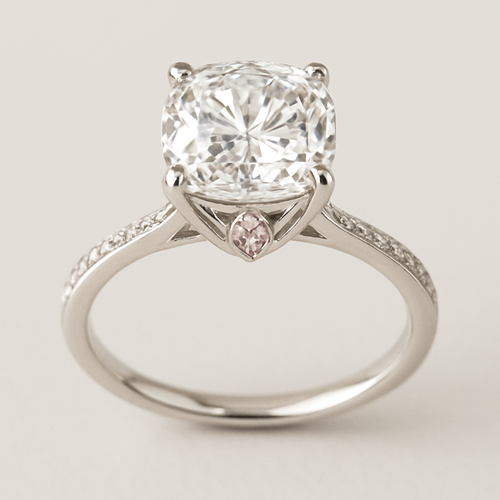 Make me a diamond engagement ring with an elongated cushion diamond that is large is shiny, silver band, but make it unique and fit for an elegant princess. Think dainty but loud and regal at the same time. Incorporate a second light pink diamond somewhere in the design Make the band thinner and have a hidden halo with a modern tulip basket setting. Dainty but regal 