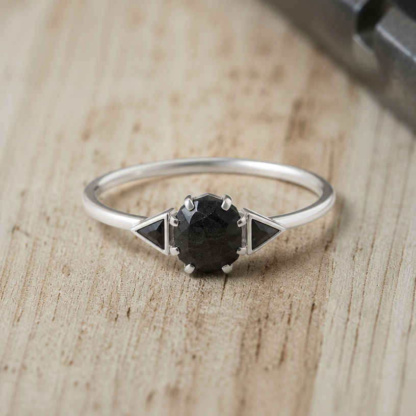 A women's ring made of silver, minimalist, simple and delicate, clean lines. take this black onyx and make some triangles outside the stone on either side
using the attached image as a visual reference, create A women's ring made of silver, minimalist, simple and delicate, clean lines. take this black onyx and make some triangles outside the stone on either side. photorealistic, just the design no text