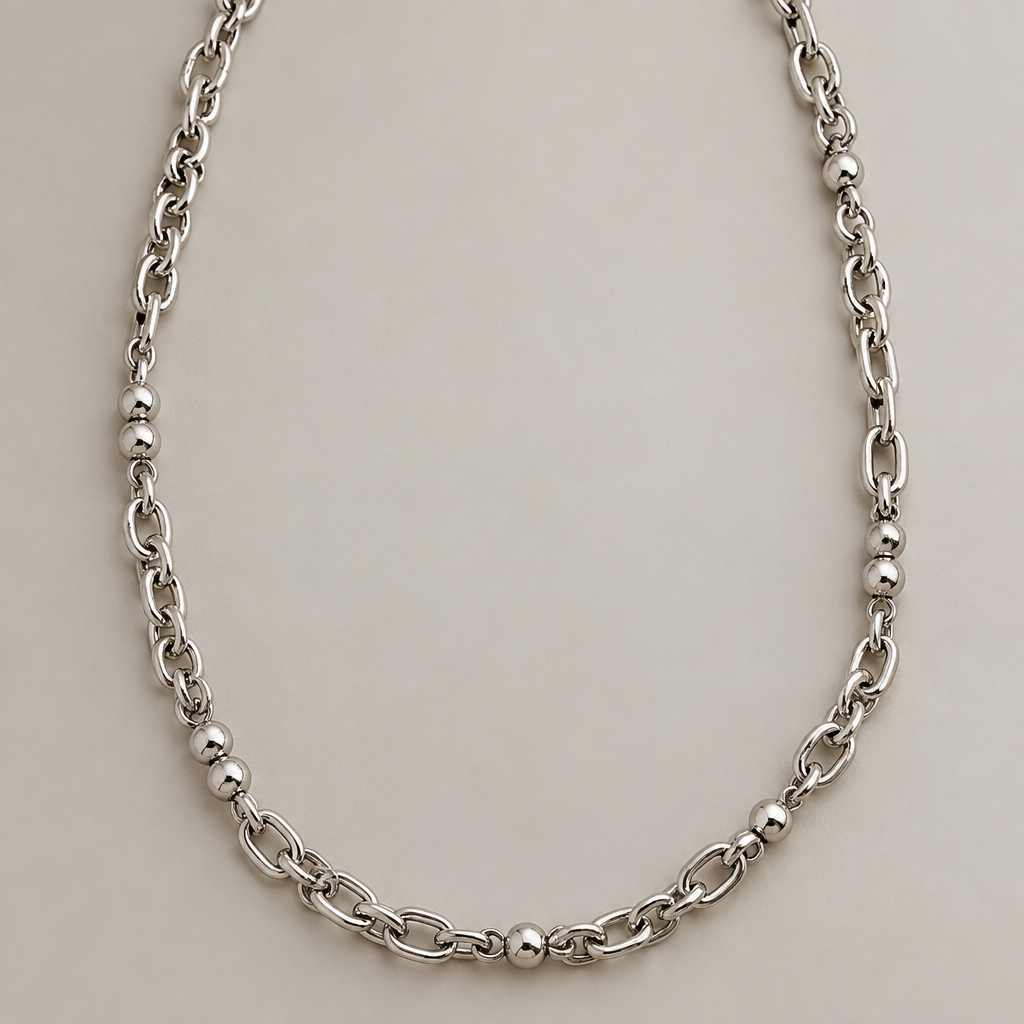 A modern women's necklace made of silver. I want a chain with a rosary-style design—but without the dangling end section—just a standard chain, 60 cm long and 2–3 cm thick. It should feature mostly chain links with just a few beads interspersed (e.g., alternating between two beads and one bead). To reiterate: I want it to be mostly chain rather than beads. Also, I’d like a different chain style—something with a fuller, more substantial look.
photorealistic jewelry design, A modern women's necklace made of silver. I want a chain with a rosary-style design—but without the dangling end section—just a standard chain, 60 cm long and 2–3 cm thick. It should feature mostly chain links with just a few beads interspersed (e.g., alternating between two beads and one bead). To reiterate: I want it to be mostly chain rather than beads. Also, I’d like a different chain style—something with a fuller, more substantial look., modern style, just the design no text