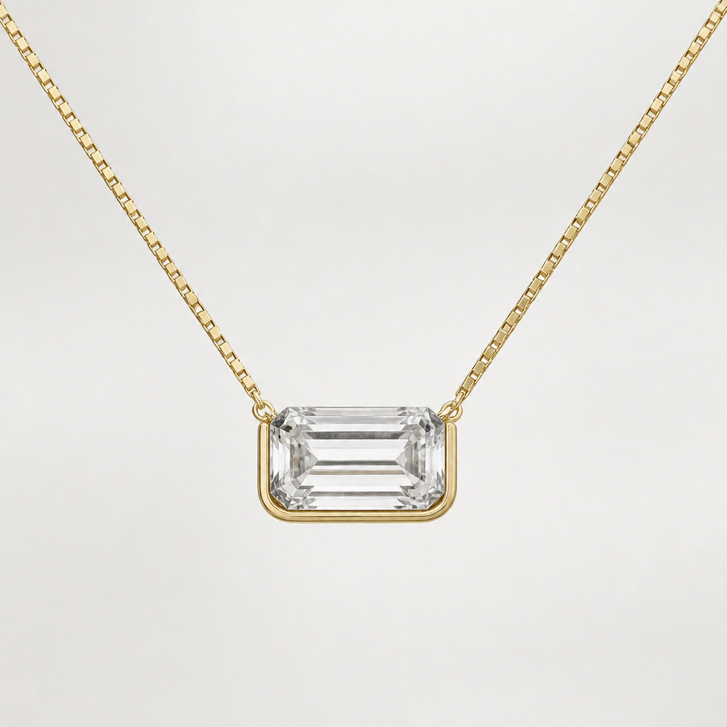 A 10ct emerald cut clear diamond necklace where the pendant is east west, half bezel so I can change the chain. Bezel is yellow gold on a thin yellow gold 14” box chain and the chain connects to the pendant in the middle of the diamond not the top corners
photorealistic jewelry design, A 10ct emerald cut clear diamond necklace where the pendant is east west, half bezel so I can change the chain. Bezel is yellow gold on a thin yellow gold 14” box chain and the chain connects to the pendant in the middle of the diamond not the top corners , modern style, just the design no text