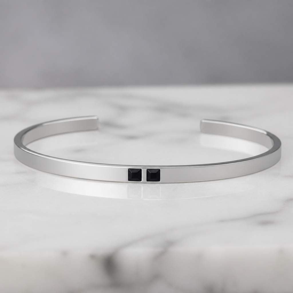 A women's bracelet made of silver. 2mm*6mm cuff bracelet with 2 black square stone in the middle the stones are flush inside the bracelet
photorealistic jewelry design, A women's bracelet made of silver. 2mm*6mm cuff bracelet with 2 black square stone in the middle the stones are flush inside the bracelet, modern style, just the design no text