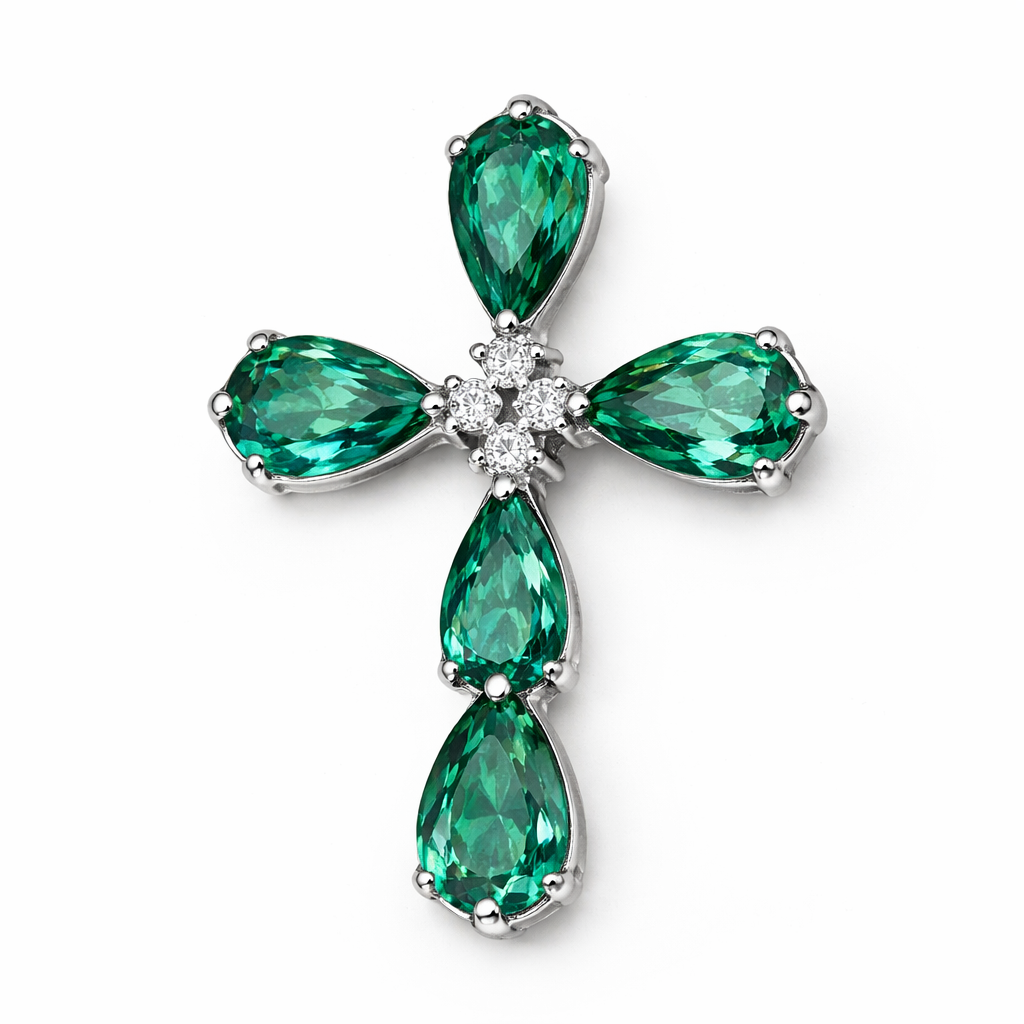 Pear cut emerald cross on 14k white gold with bale attached to the back and not shown. Few diamond accent stones. Classic, simple, and elegant