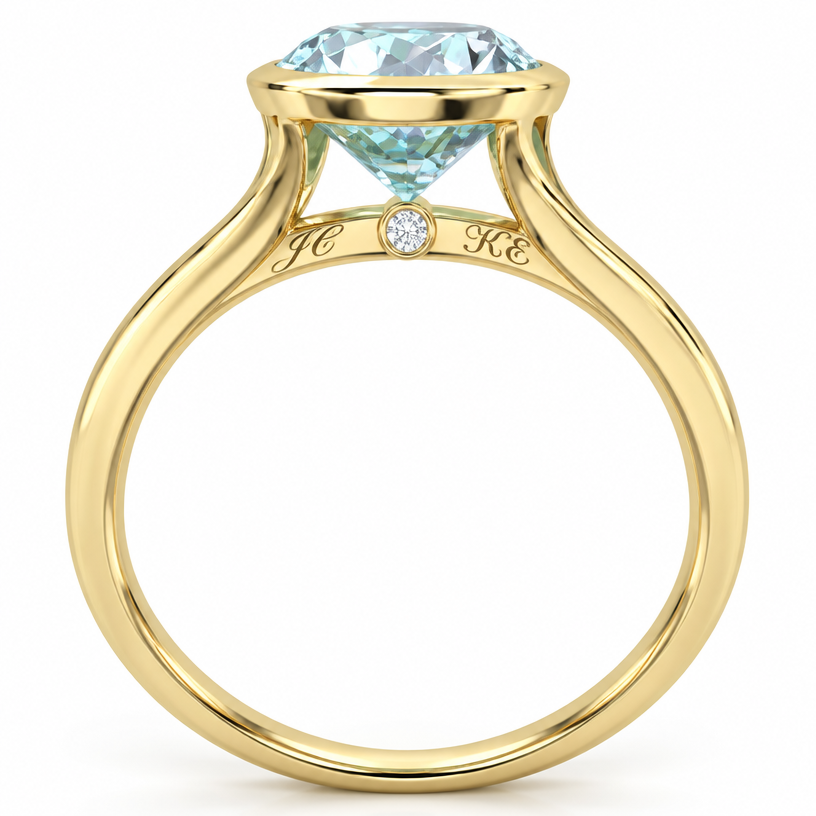 A women's ring. Aquamarine cathedral bezel yellow gold ring with single very small diamond in the middle of the bridge with the initials JC on the left side and initials KE on the right side engraved in cursive slanted lettering along with line of the bridge
using the attached image as a visual reference, create A women's ring. Aquamarine cathedral bezel yellow gold ring with single very small diamond in the middle of the bridge with the initials JC on the left side and initials KE on the right side engraved in cursive slanted lettering along with line of the bridge. photorealistic, just the design no text