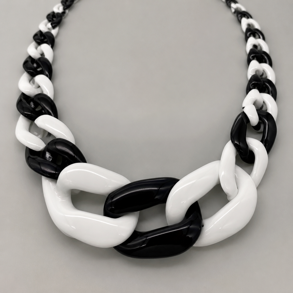 A women's necklace. create a chunky Cuban links style plastic necklace that is graduated and exaggerated in the first three links.colors: alternating black and white
photorealistic jewelry design, A women's necklace. create a chunky Cuban links style plastic necklace that is graduated and exaggerated in the first three links.colors: alternating black and white, modern style, just the design no text