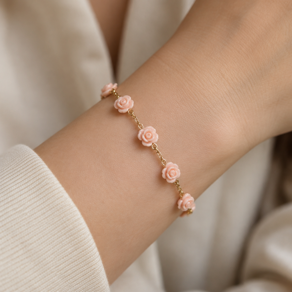 A women's ring. Create a delicate 18K gold bracelet using 5 to 7 identical tiny rose charms copied from my reference photo. All flowers must have exactly the same small size, pale blush pink color, glossy finish, and layered rose petals. Connect them with a thin gold chain, leaving small spaces between the flowers. No gemstones or diamonds. Show the bracelet worn on a woman's wrist, realistic proportions.
photorealistic jewelry design, A women's ring. Create a delicate 18K gold bracelet using 5 to 7 identical tiny rose charms copied from my reference photo. All flowers must have exactly the same small size, pale blush pink color, glossy finish, and layered rose petals. Connect them with a thin gold chain, leaving small spaces between the flowers. No gemstones or diamonds. Show the bracelet worn on a woman's wrist, realistic proportions., modern style, just the design no text