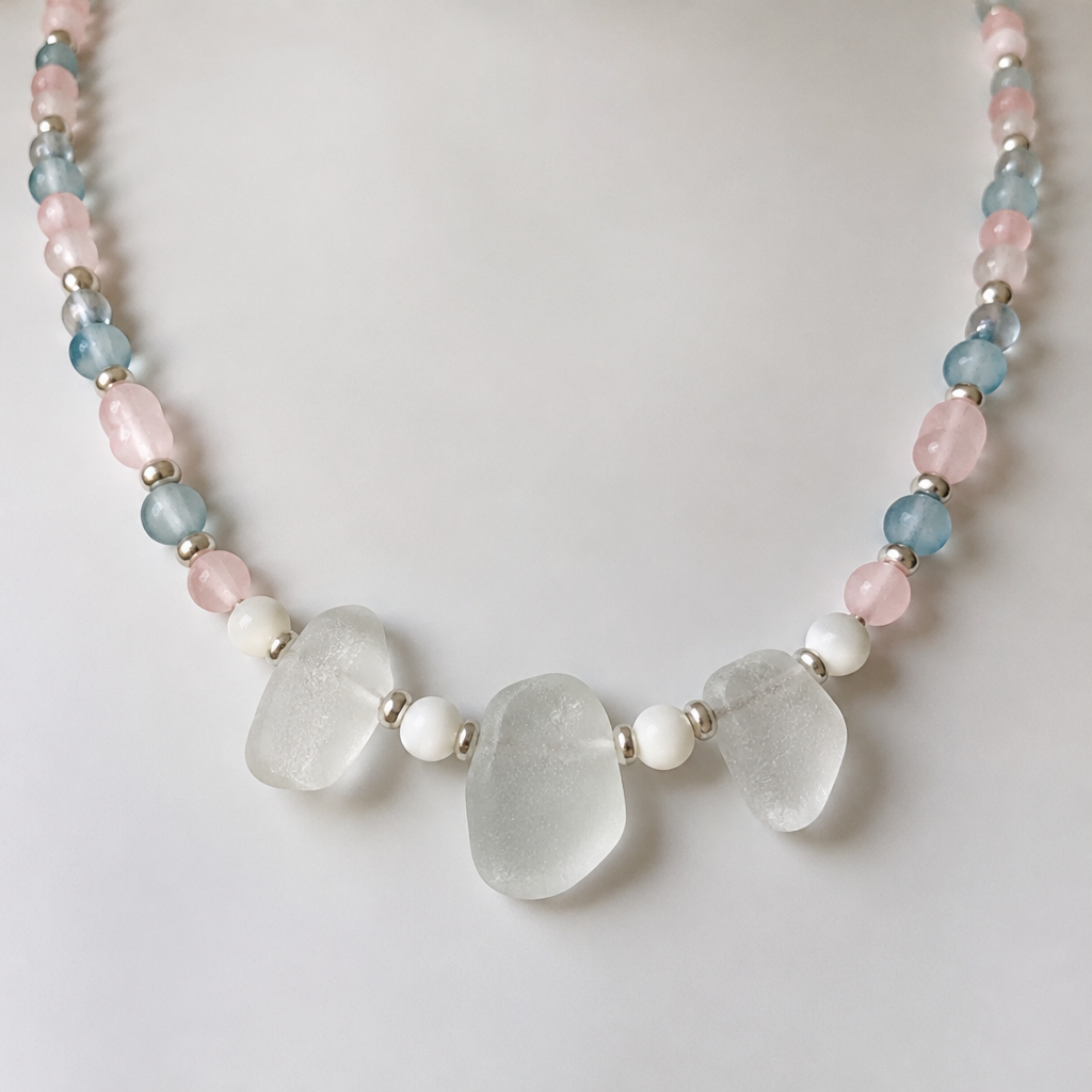 A women's necklace. pink and blue beads with 3 pieces of clear seaglass in the middle with white beads between them
photorealistic jewelry design, A women's necklace. pink and blue beads with 3 pieces of clear seaglass in the middle with white beads between them, modern style, just the design no text