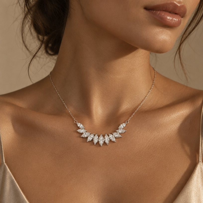 Jewelry photoshoot (worn)
Show the jewelry piece from the image worn by an elegant model in a professional editorial photograph, soft studio lighting. Reproduce the jewelry's exact design, metal, stones and details faithfully. Photorealistic, no text. Additional instructions: A close-up, elegant editorial fashion photograph focusing on a person's collarbone and neck. The subject is wearing a delicate, thin gold chain necklace adorned with a subtle curved arc of small, sparkling diamond crystals resting gracefully on the skin. Warm, soft directional light creates deep, aesthetic shadows and highlights the rich warm-toned skin texture. Minimalist beige neutral backdrop, subtle film grain texture, moody vintage aesthetic, high-end jewelry commercial style, shot on 35mm lens, 8k resolution..