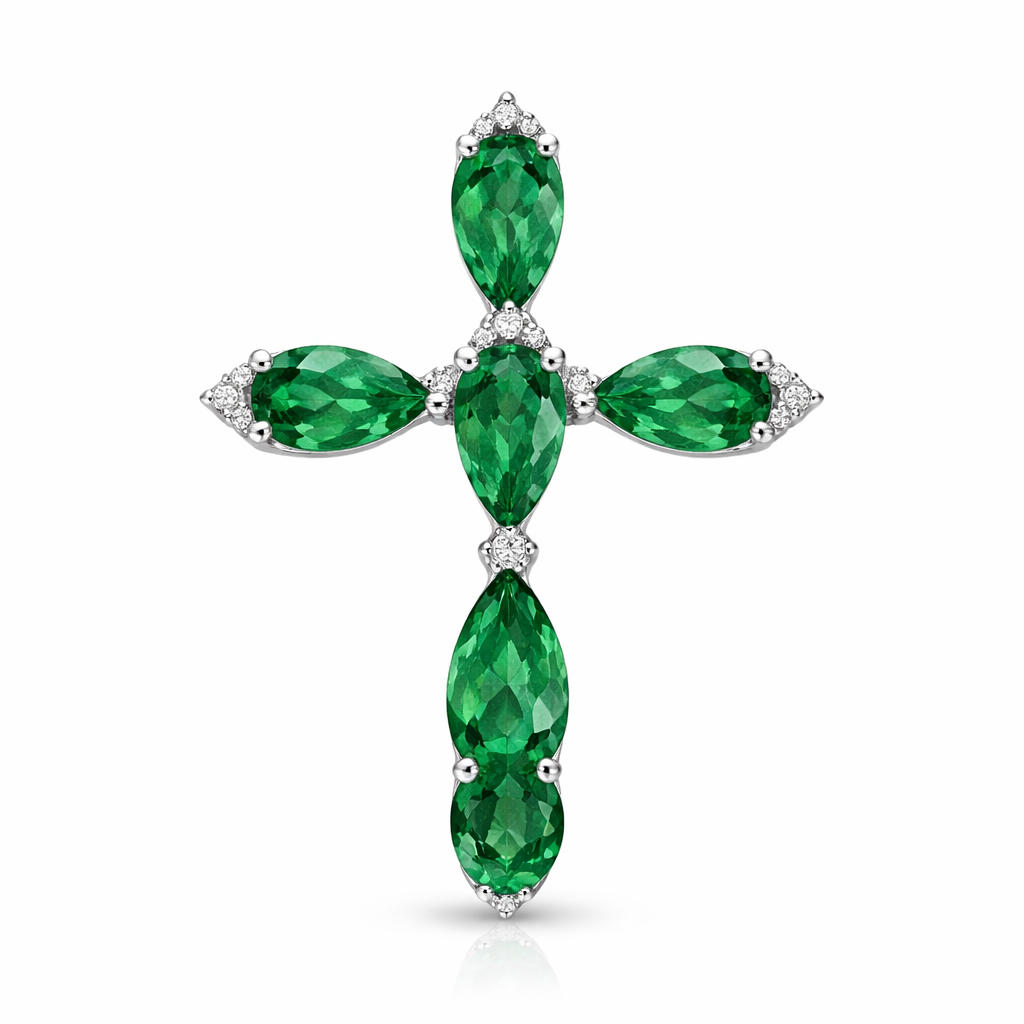 Pear cut emerald cross on 14k white gold with bale attached to the back and not shown. Few diamond accent stones. Classic, simple, and elegant