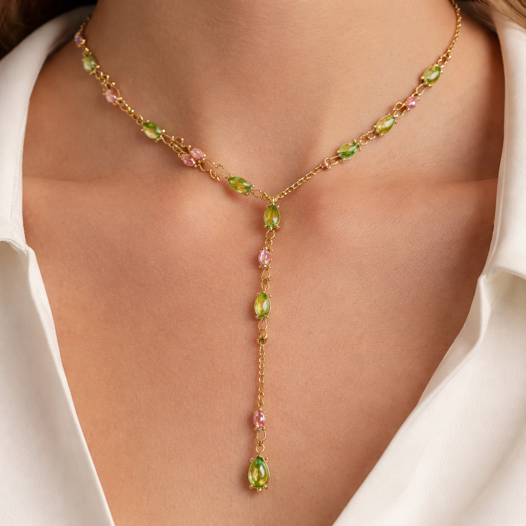 Everyday piece. Thin Gold chain with thin wire wrapped around it like an olive branch and small pear cut bright peridot and pink sapphire stones placed throughout the chain with a lariat.
