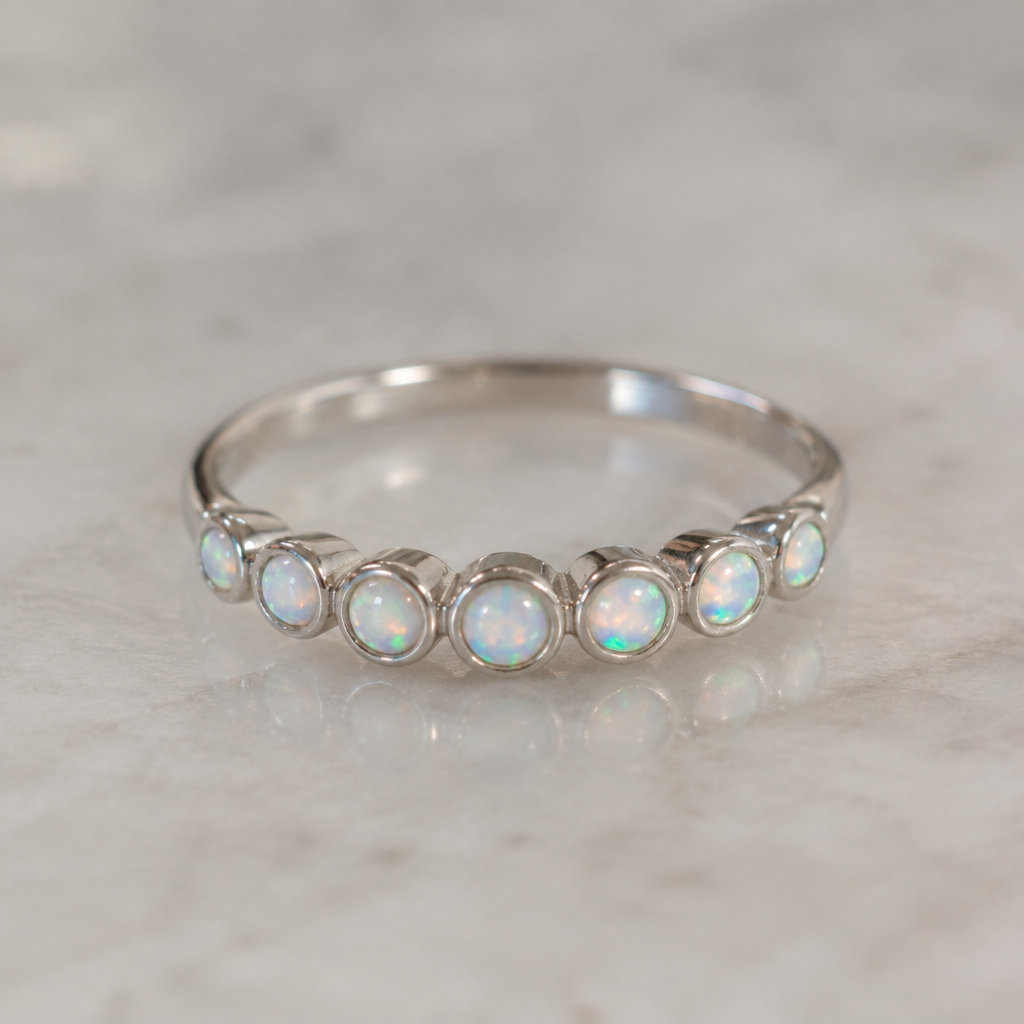 A women's ring made of silver, minimalist, simple and delicate, clean lines. multiple 2mm flat bottom opals in bezel settings
photorealistic jewelry design, A women's ring made of silver, minimalist, simple and delicate, clean lines. multiple 2mm flat bottom opals in bezel settings, modern style, just the design no text