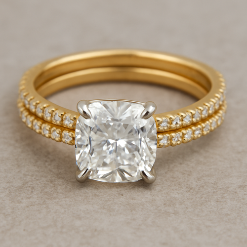 Cushion-cut center stone, 1.62 carat. Warm yellow-gold eternity pavé band. Delicate 	platinum prongs. Small 	pavé wedding bands with white diamonds . Natural photo lighting, life-size scale