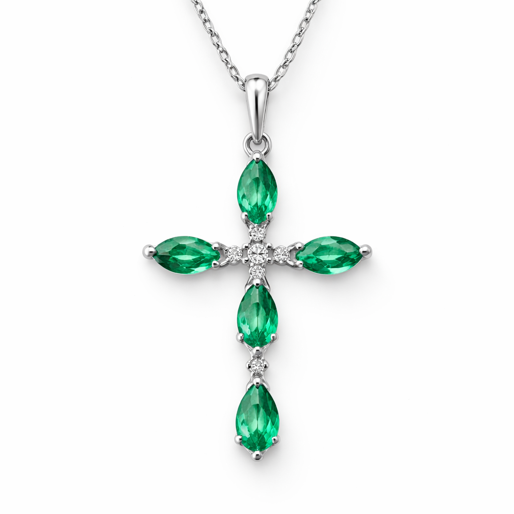 Simple and timeless pear cut emerald white gold cross with minimal diamond accents. Light metal work.