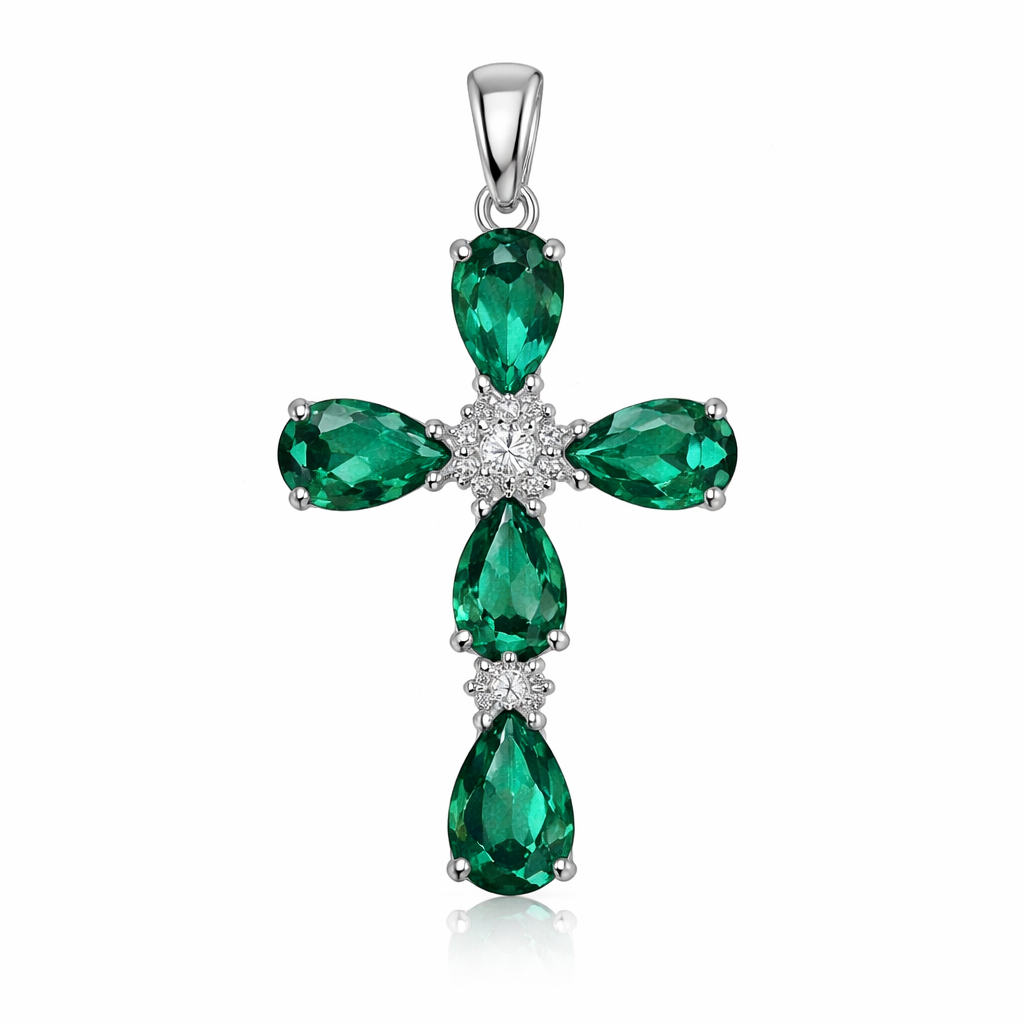 Faceted pear cut emerald white gold cross with 2 small diamond accent stones in between each emerald. White gold bale with no diamonds.