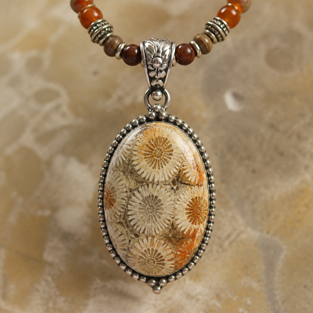 "Cream colored with orange and brown and some grey inclusions oval shaped fossilized coral 30mm x 20.5mm necklace
photorealistic jewelry design, "Cream colored with orange and brown and some grey inclusions oval shaped fossilized coral 30mm x 20.5mm necklace , bohemian style, just the design no text