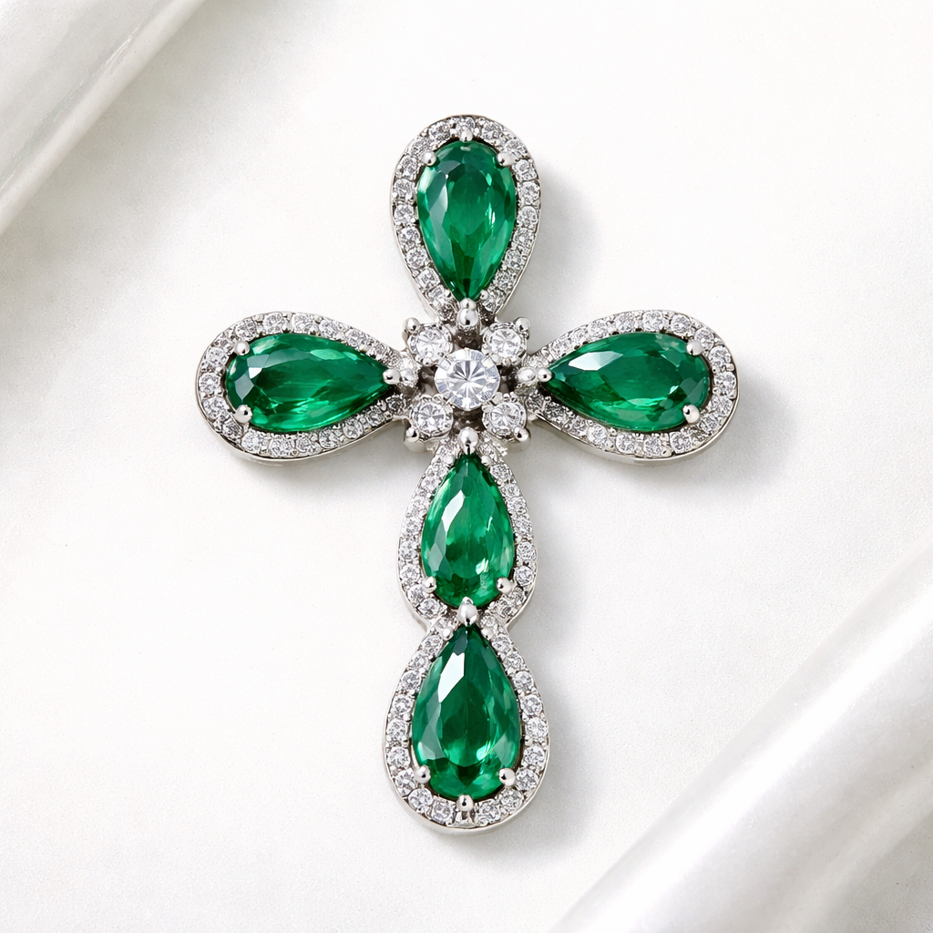 Pear cut Emerald white gold cross and with simple diamond accent stones. Timeless, elegant, and classy. Hidden bail. Light metal work.