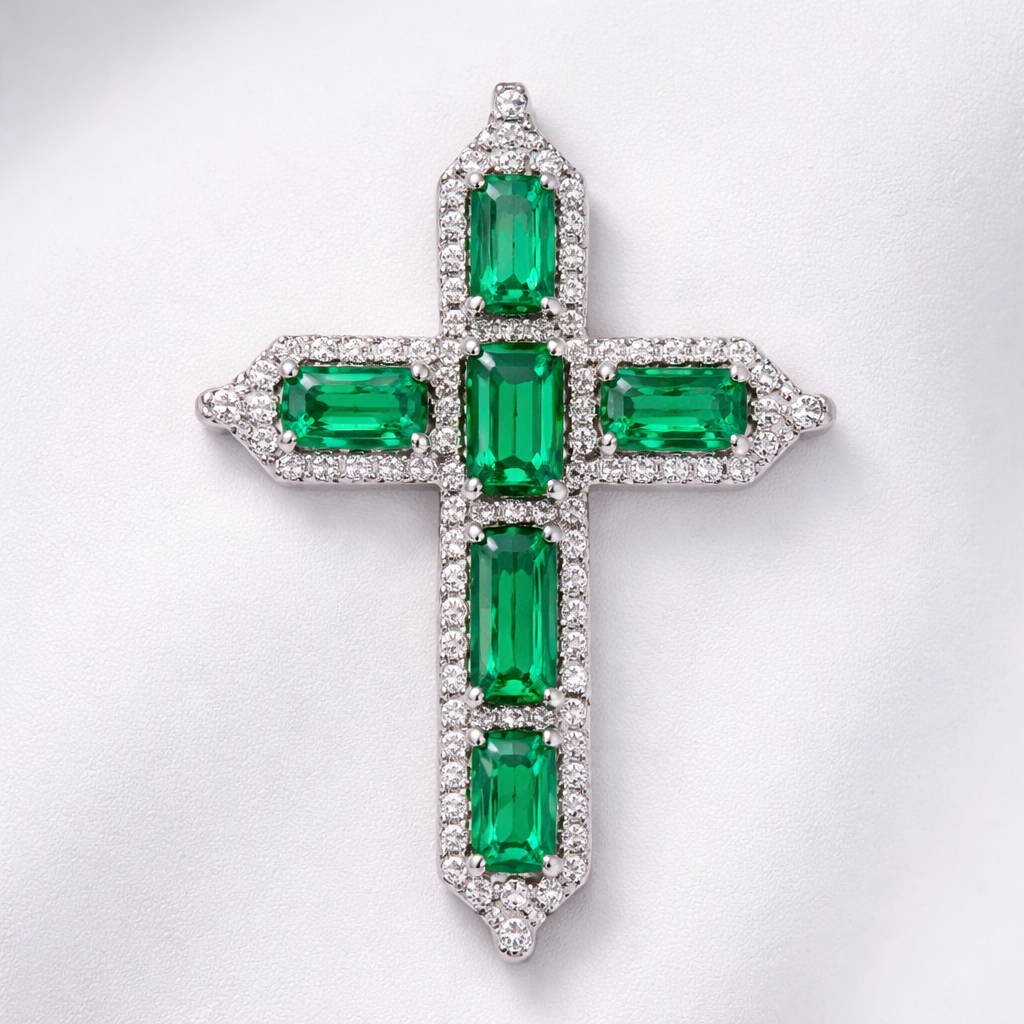 Emerald white gold cross and with simple diamond accent stones. Timeless, elegant, and classy. Hidden bail.
