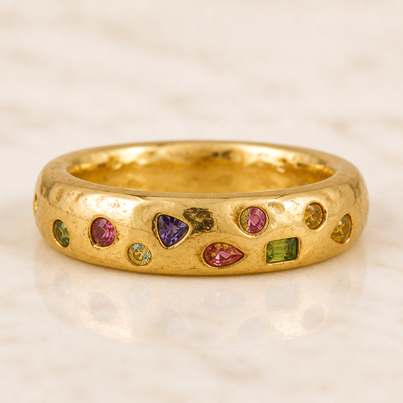 The band is double the thickness and the stones are all mixed up, not in a neat row. The whole piece should be less neat and rougher gold
edit the attached jewelry design with these instructions: The band is double the thickness and the stones are all mixed up, not in a neat row. The whole piece should be less neat and rougher gold. keep it photorealistic, just the design no text