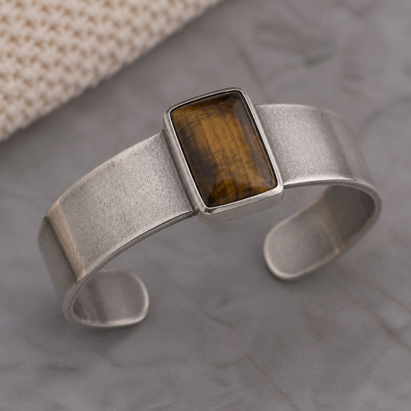 A women's bracelet made of silver. silver cuff with patina
using the attached image as a visual reference, create A women's bracelet made of silver. silver cuff with patina. photorealistic, just the design no text