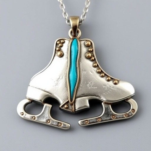 Silver pendant in the shape of ice skating blades with a turquoise stripe within the blade
