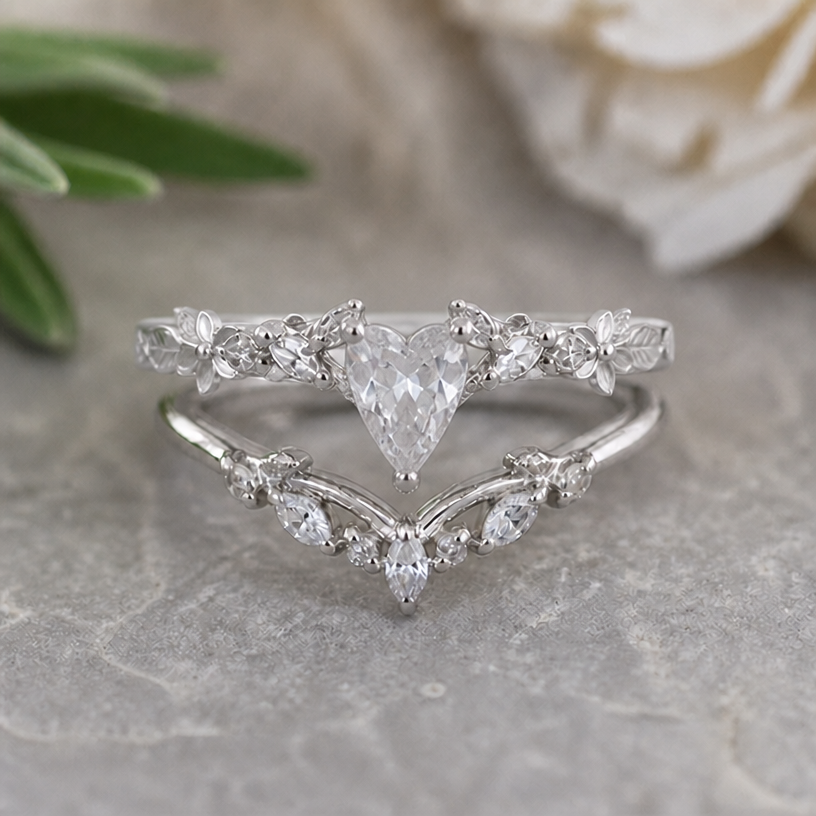 Please adjust the form of the main stone of the upper ring so it matches with the v form of lower ring
edit the attached jewelry design with these instructions: Please adjust the form of the main stone of the upper ring so it matches with the v form of lower ring. keep it photorealistic, just the design no text
