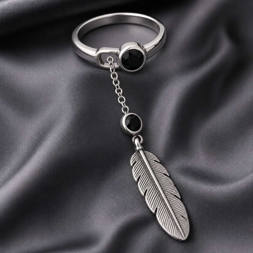 A classic women's ring made of silver. large stainless steel feather on a chain with black gemstone
using the attached image as a visual reference, create A classic women's ring made of silver. large stainless steel feather on a chain with black gemstone. photorealistic, just the design no text
