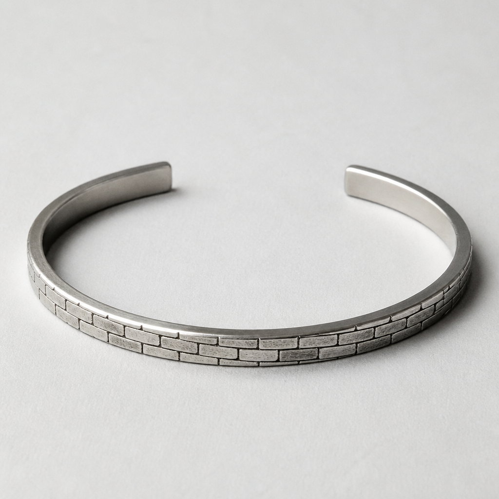 A men's bracelet made of silver, minimalist, simple and delicate, clean lines. 3mm square cuff with brick texture
photorealistic jewelry design, A men's bracelet made of silver, minimalist, simple and delicate, clean lines. 3mm square cuff with brick texture, modern style, just the design no text