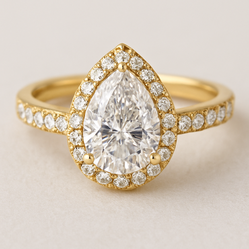 Pear shaped, white diamond , band width 3 mm , gold ring, halo around the diamond and small diamond on the sides of the ring