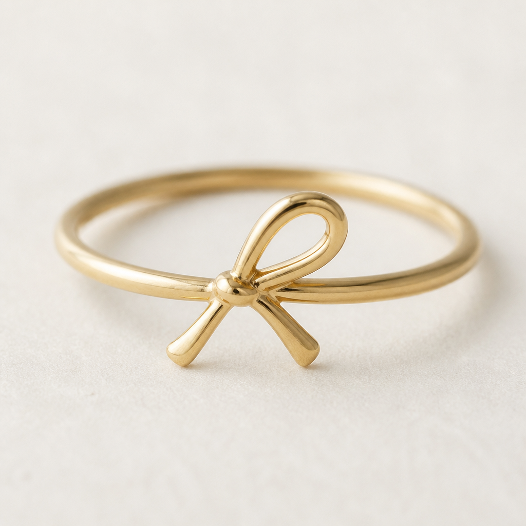 A minimalist women's ring made of gold suitable for gift. the ribbon design that tilted a little bit to the right and the ribbon design is very simple not to crowded design . between the loop inside the ribbon is empty. the ring is go around the ribbon not on top of the ring
photorealistic jewelry design, A minimalist women's ring made of gold suitable for gift. the ribbon design that tilted a little bit to the right and the ribbon design is very simple not to crowded design . between the loop inside the ribbon is empty. the ring is go around the ribbon not on top of the ring, minimalist style, just the design no text