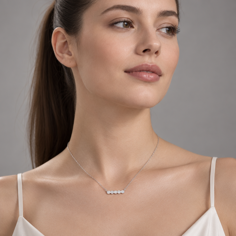 Jewelry photoshoot (worn)
Show the jewelry piece from the image worn by an elegant model in a professional editorial photograph, soft studio lighting. Reproduce the jewelry's exact design, metal, stones and details faithfully. Photorealistic, no text. Additional instructions: "Photorealistic, close-up editorial shot of an elegant young woman with soft, natural features, her hair pulled back into a sleek high ponytail, standing with her shoulders squared and chin gently lifted, a calm and confident expression on her face, eyes looking slightly off-camera. Soft studio lighting wraps gently around her neck and collarbone, creating a subtle, flattering glow. She is wearing a delicate, minuscule sterling silver necklace featuring a tiny polished cross pendant, resting naturally at the base of her throat. She is not wearing any earrings. Minimalist soft grey studio backdrop, shallow depth of field, sharp focus on the necklace and skin texture, soft bokeh elsewhere. 8k resolution, cinematic quality, luxury jewelry campaign aesthetic. Make sure the necklace chain stays as it is in the picture, meaning do not add any stones to it.
Jewelry scale note: the cross pendant must be tiny, delicate and realistically proportioned — not oversized or exaggerated, true to how fine jewelry actually looks in real life.".